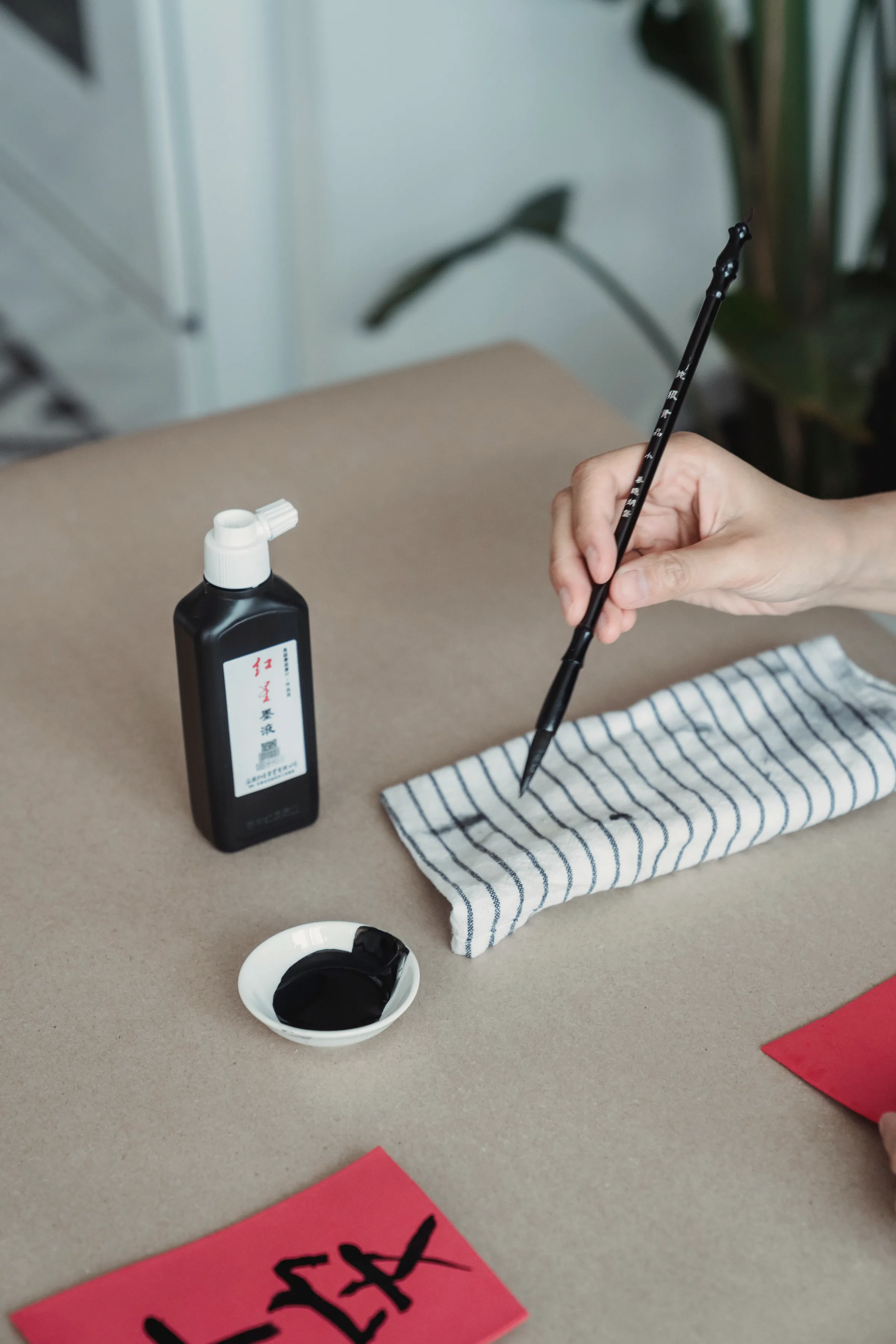 A brush loaded with ink resting on a stone slab