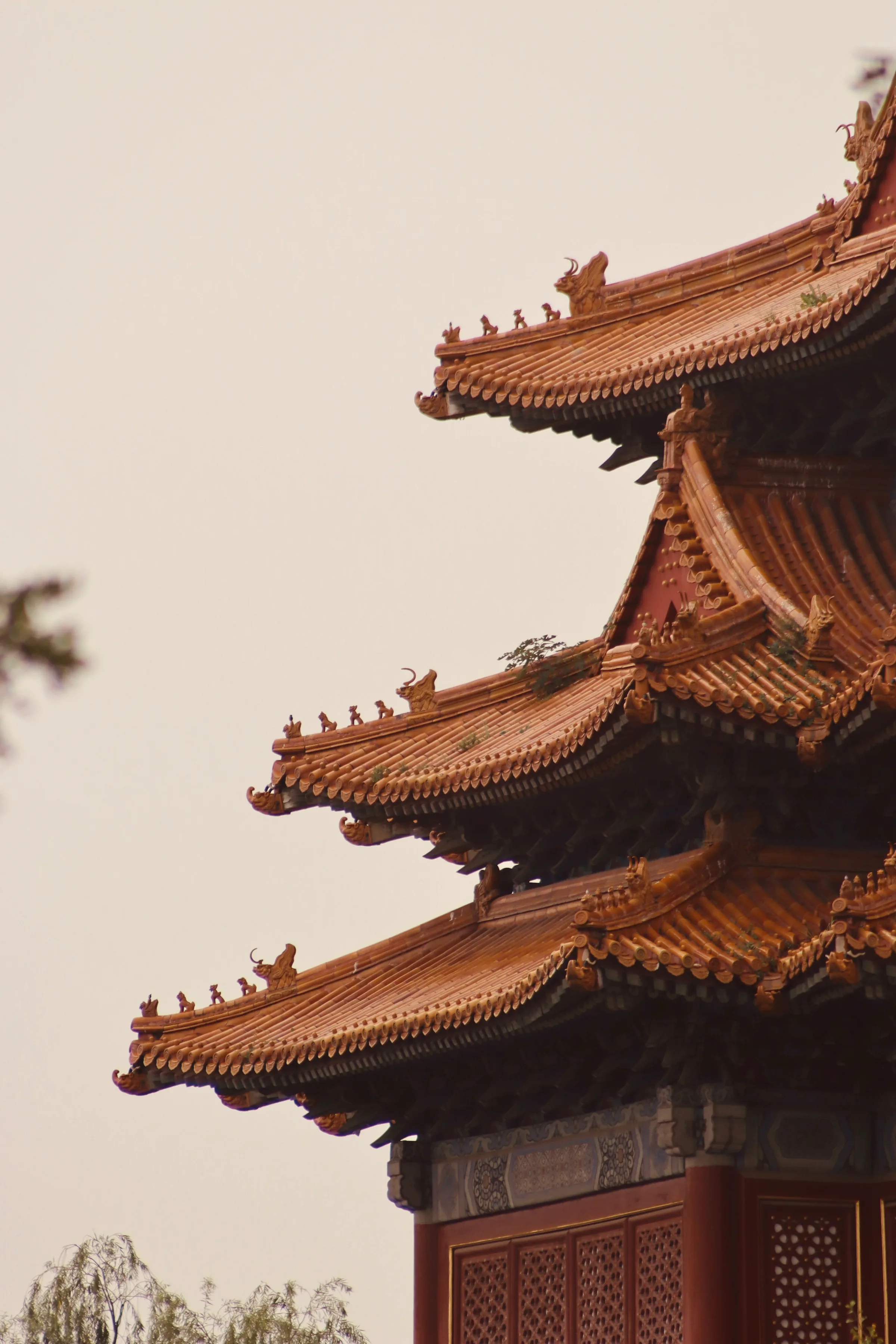 Glazed roof ridge with figure ornaments against an early sky