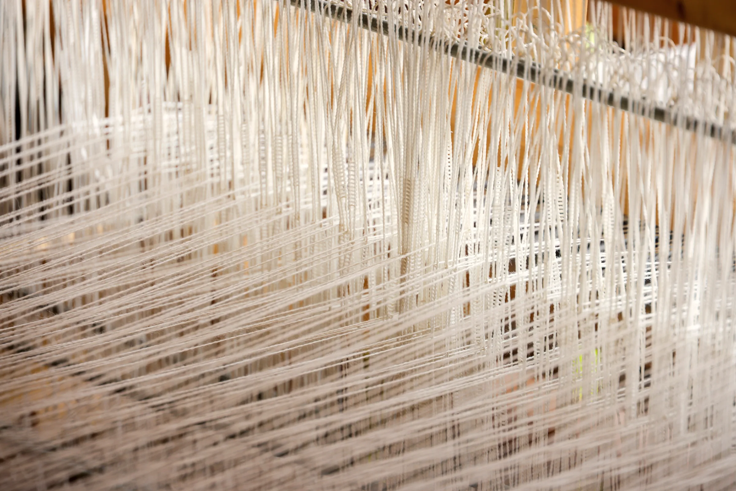 A hand loom part-way through a woven length